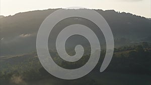 Amazing time lapse during the sunrise in the lands of Tuscany-Italy. Warm colors on the hills and haze