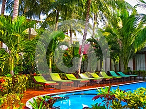 Amazing top view on swimming pool at tropical hotel near ocean