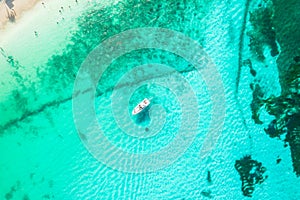 Amazing top view of yacht. Aerial view of luxury floating small ship in blue Caribbean sea. Yacht at the sea in Cancun