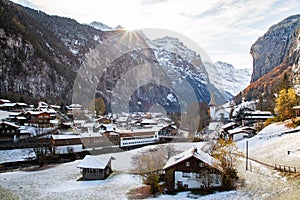 amazing touristic alpine village in winter with famous church and Staubbach waterfall  Lauterbrunnen  Switzerland  Europe