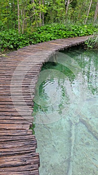 Amazing touristic wooden pathway in the colorful deep forest with clean lakes and spectacular waterfalls, Plitvice National Park,