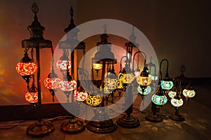 Amazing traditional handmade turkish lamps in souvenir shop. Mosaic of colored glass. Lit in the evening