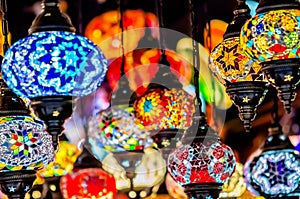 Amazing traditional handmade turkish lamps in souvenir shop. Mosaic of colored glass. Lit in the evening, creating a cozy atmosphe