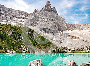 Amazing turquoise Sorapis lake in the mountains in Dolomites, Italy
