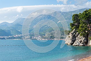 Amazing view on the Adriatic sea and mountains from Montenegro. Rocky cliff in clean turquoise water in beach of Budva. View of