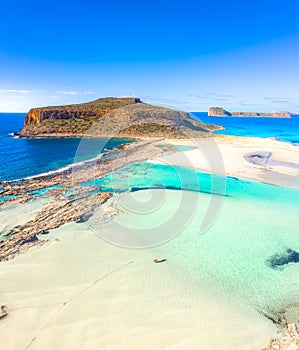 Amazing view of Balos Lagoon with magical turquoise waters, lagoons, tropical beaches of pure white sand and Gramvousa island on C