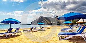 Amazing view of beach las Teresitas with yellow sand, umbrellas, longues and palm trees. Location: Santa Cruz de Tenerife,