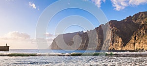 Amazing view of beach in Los Gigantes with high cliffs on the sunset. Location: Los Gigantes, Tenerife, Canary Islands. Artistic