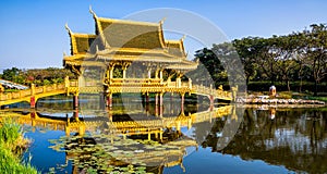 Amazing view of beautiful Golden Bridge and Pavilion of the Enlightened with reflection in the water. Location: Ancient City Park photo