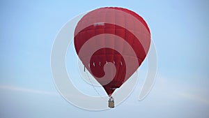 Amazing view of beautiful red hot air balloon flying in the sky, freedom