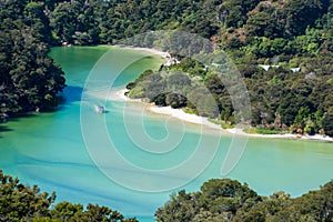 Amazing view of boat in a turquoise lagoon in Abel Tasman National Park, New Zealand