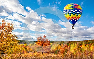 Amazing view of colorful autumn trees with hot air balloon. Concept for fall background. Artistic picture. Beauty world