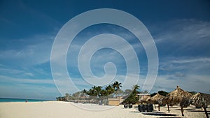 Amazing view on Eagle Beach of Aruba Island. Caribbean. Turquoise sea water and blue sky. Time lapse