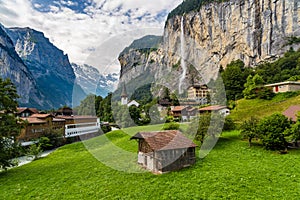 Amazing view of famous Lauterbrunnen town in Swiss Alps valley with Staubbach waterfalls in the background, Switzerland