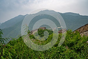 Amazing view of Great Wall of China mountains and green trees in a background