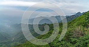 Amazing view from Great Wall of China mountains and green trees in a background