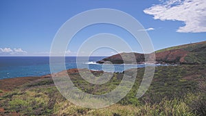 Amazing view of Hanauma Bay Oahu Hawaii. The turquoise waves of the Pacific Ocean wash over volcanic rocks. Summer