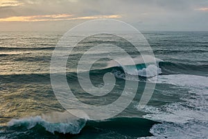 Amazing view of the huge ocean waves. Stormy ocean at sunset. Nazare, Portugal