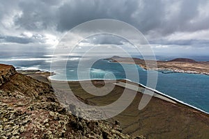 Amazing view on La Graciosa island from Mirador del Rio on a cloudy day, Lanzarote, Spain