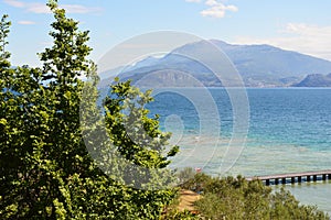 Amazing view of Lake Garda from the hills of the park Parco Pubblico Tomelleri in Sirmione town, Italy