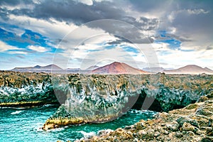 Amazing view of lava`s caves Los Hervideros and volcanoes in Lanzarote island, popular touristic attraction. Location: Lanzarote,