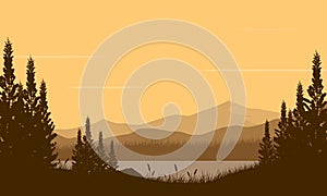 Amazing the view of the mountain view with pine tree silhouette from the riverside at dusk