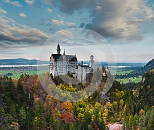 Amazing view of Neuschwanstein castle in autumn season at sunset. Bavaria, Germany. Neuschwanstein castle one of the most popular