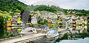 Amazing view of the pier with boats in Norheimsund near Steinsdalsfossen. Location: Norheimsund, Hardangerfjord, Norway. photo