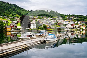 Amazing view of the pier with boats in Norheimsund near Steinsdalsfossen. Location: Norheimsund, Hardangerfjord, Norway. photo