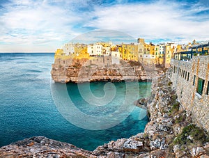 Amazing view on Polignano a Mare village on the rocks at sunset