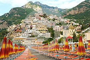Amazing view of Positano town from the beach with umbrellas and deck chairs, Amalfi Coast, Italy