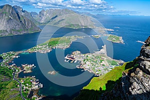 Amazing view from Reinebringen view point. Mountains and blue sea at Lofoten islands. Scenery of Reine fishing village