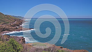 Amazing view of the rocky coast of Oahu Hawaii. The turquoise waves of the Pacific Ocean wash over volcanic rocks