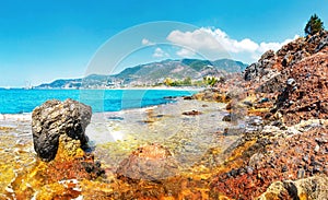 Amazing view on rocky tropical beach on sunny summer day in Alanya, Turkey. Turkish seascape with mountains and rocks