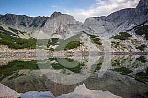 Amazing view of roks around Sinanitsa Peak and reflection in the lake, Pirin Mountain