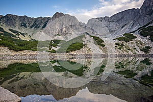 Amazing view of roks around Sinanitsa Peak and reflection in the lake, Pirin Mountain photo