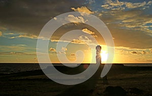 Amazing view of the setting sun shining through the silhouette of Moai statue of Ahu Ko Te Riku, Tahai , Easter Island, Chile photo