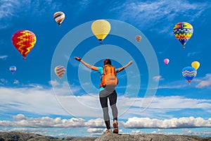 Amazing view with sport girl and a lot of hot air balloons. Artistic picture. Beauty world. The feeling of complete freedom