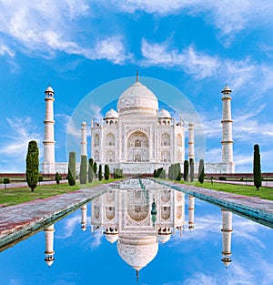 Amazing view on the Taj Mahal in sun light with reflection in wa