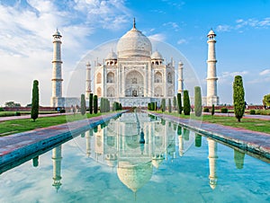 Amazing view on the Taj Mahal in sunset light with reflection in water. The Taj Mahal is an ivory-white marble mausoleum on the