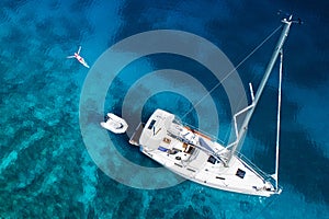 Amazing view to yacht, swimming woman and clear water in caribbean paradise