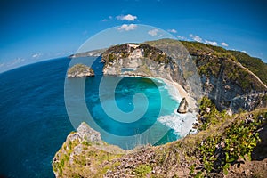 Amazing view of a tropical beach with coconut palms and rocks