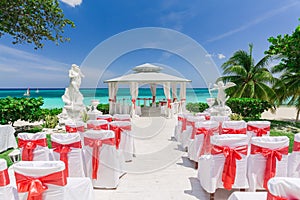 Amazing view of wedding ceremony event decorated gazebo against blue sky and ocean background