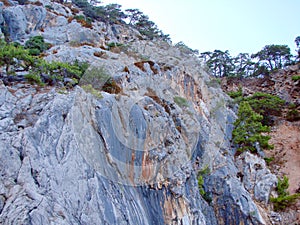 Amazing views from a pleasure yacht on the rocky coast of the Lycian Trail washed by the azure sea.