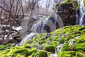 Amazing waterfall stream in forest, early spring. Nature landscape. Waterfall Siga. Homolje mountains photo
