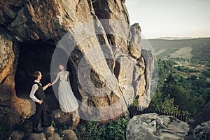 Amazing wedding couple is hugging each other in mountains