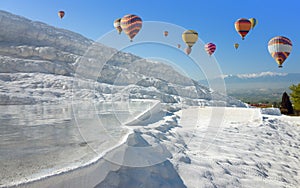 Hot air ballons flying above white Pamukkale, Turkey photo
