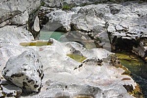 Amazing wild water in mala korita Soce valley, small pure clear turquoise flowing stream through stone gorge