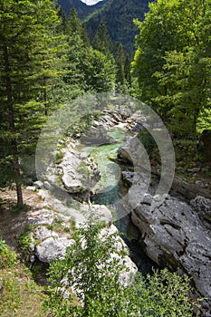 Amazing wild water in mala korita Soce valley, small pure clear turquoise flowing stream through stone gorge