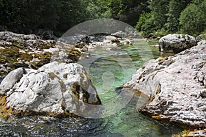 Amazing wild water in mala korita Soce valley, small pure clear turquoise flowing stream through stone gorge